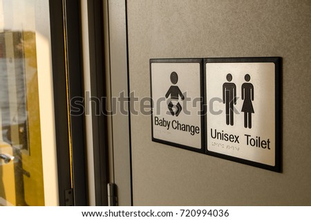 Unisex toilet and baby change or parent room signs.