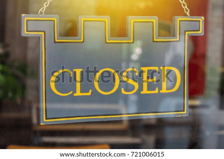 Close of a closed sign on the door glass.