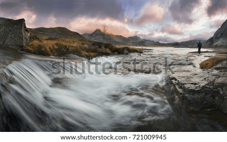 Landscape photographer at work in a norwegian river