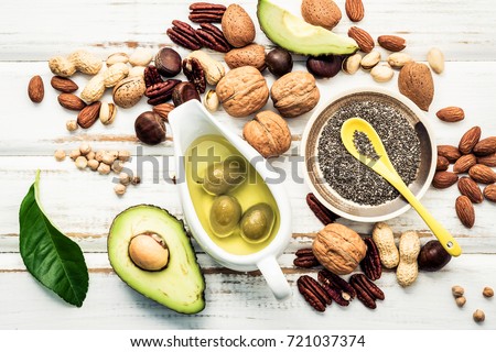 Selection food sources of omega 3 and unsaturated fats. Superfood high vitamin e and dietary fiber for healthy food. Almond ,pecan,hazelnuts,walnuts and olive oil on stone background. Royalty-Free Stock Photo #721037374