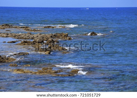 Beautiful blue sea wave background on the stones near the shore and foam. Contrast bright portrait