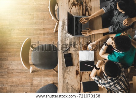 Multiracial group of young students studying, Teenage sitting together at table with books and laptop for researching information for their project. co-working space, top view Royalty-Free Stock Photo #721070158