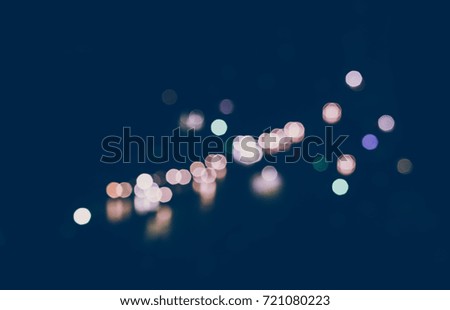Night colorful lights glow, de focused. Abstract background, depicting European street, reflection on the wet asphalt.