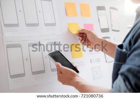 Web designer, UX UI designer planning application for mobile phone. Royalty-Free Stock Photo #721080736
