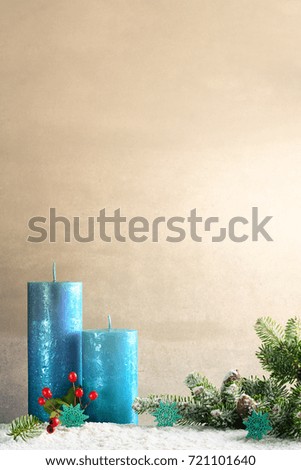 Christmas decoration with green twig and blue candles with copy space.