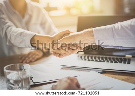 Business people shaking hands, finishing up meeting. Successful businessmen handshaking after good deal. Royalty-Free Stock Photo #721102051