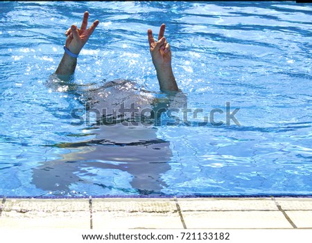A man swimming underwater in Swimming Pool. Resorts in Alanya, Turkey. The peace sign. Tagil rulit. Print for t shirt