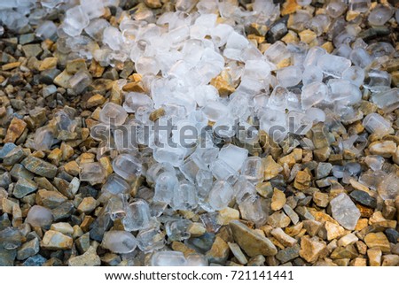 Close up of ice cubes on the ground, gravel