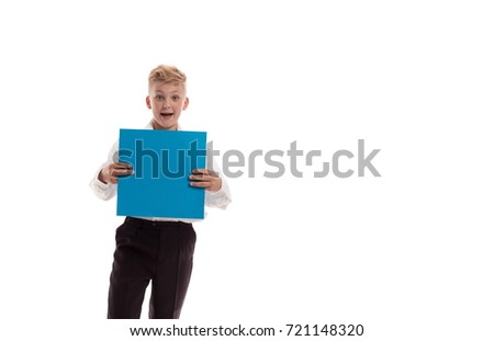 Emotional blond boy in white shirt is holding a blue sheet of paper for notes, posing against white background