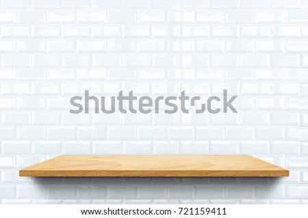 Empty wood plank shelf at white ceramic tile wall pattern background,Mock up for display or montage of product or design.