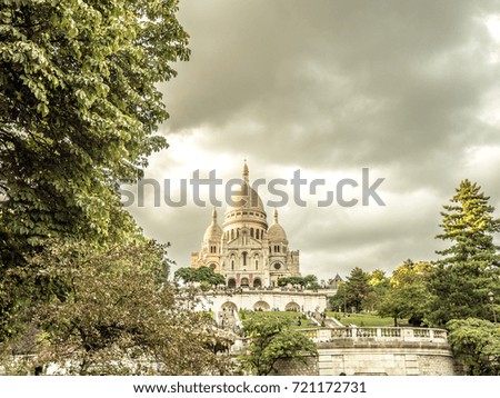 View of the world renown famous Sacre Coeur basilica church at top of butte Montmartre, the highest point in Paris France with beautiful classic architectural white domes and tower