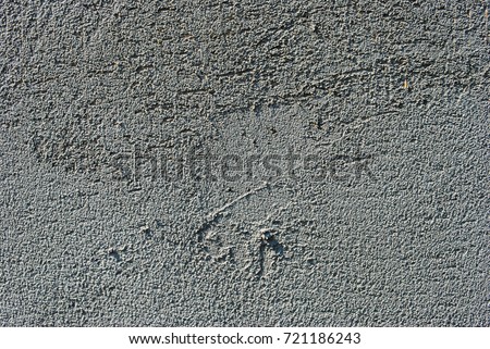 Gray concrete wall. Small cracks on the surface