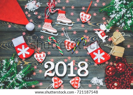 Christmas background with decorations. New Year 2018. Gifts in handicraft paper, Spruce branches, red hearts, balls, and many other New Year festive decorations. Horizontal view, top view.