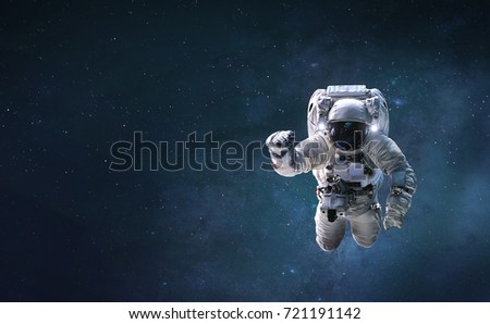 Astronaut in outer deep space in milky way galaxy. Elements of this image furnished by NASA.