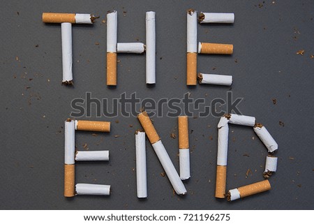 The end of smoking. Cigarettes cause cancer and kill. Gray background.