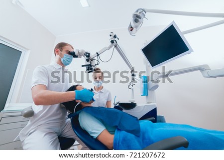 Obturation of root canals during endodontic treatment. Modern technology Royalty-Free Stock Photo #721207672