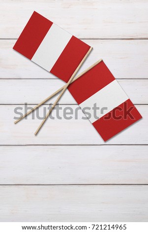 Two flags on a painted wood background