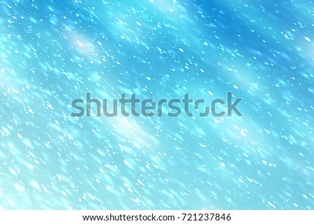 Abstract bokeh glitter lights and rays on blue background. Round defocused circle particles. Christmas template