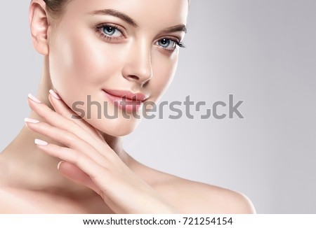 Beautiful Young Woman with Clean Fresh Skin . Facial  treatment   . Cosmetology , beauty  and spa .  Skin care Royalty-Free Stock Photo #721254154