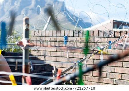 Barbwire wall for security at prison and clothesline clothes pins