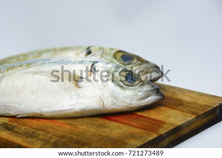Fresh Mackerel Fish On Chopping Board Over White Background