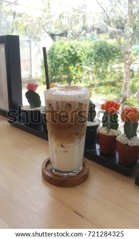 Cold cappuccino placed on wooden table