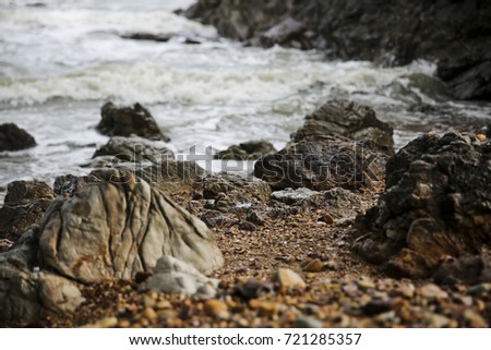 wave splashing against rock on the beach