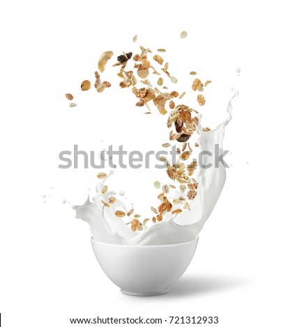 bowl of muesli with milk splash isolated on white Royalty-Free Stock Photo #721312933