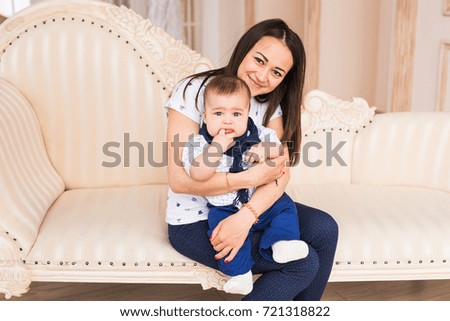 Close up of mother holding newborn baby in arms