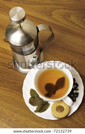 Green tea in a white cup on a dark wooden background