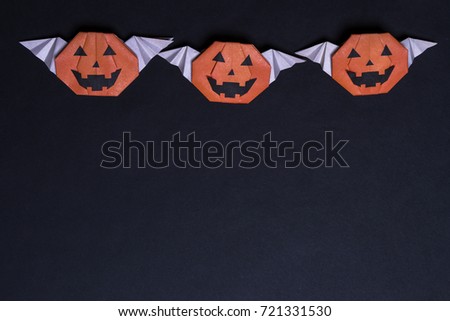 Black Halloween. On a black background made from paper pumpkin