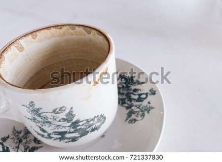 Empty coffee cup with saucer on white marble table