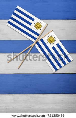 Two flags on a painted wood background