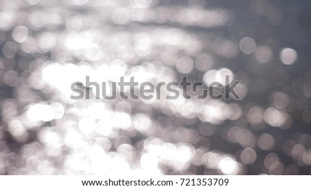 Beautiful abstract silver glittering lights bokeh Christmas background.