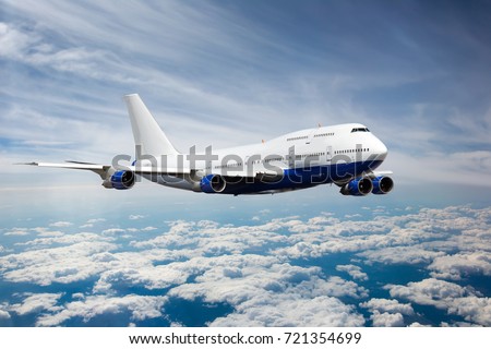 Passenger jet plane in the sky. Airplane flies high above the clouds. Royalty-Free Stock Photo #721354699