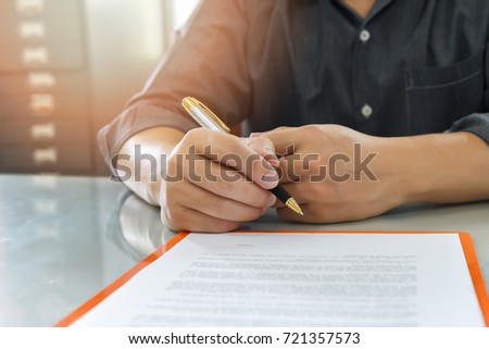 Close up of business man signing contract making a deal, business contract details. Businessman signing an official document