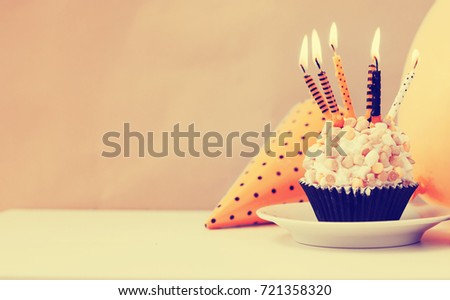 Delicious birthday cupcake  with candels on table 