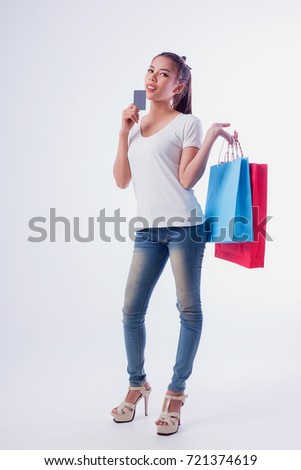Pictures of beautiful cheerful girls in summer dress, holding dollar bills with shopping bags and looking at camera through white background.