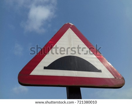 triangle Traffic symbol of bumper ahead in red and white color with blue sky background