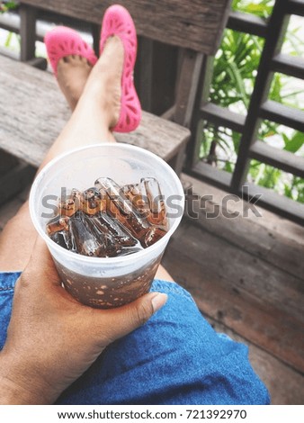 Woman drinking cola with hand