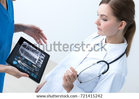 young female doctor meeting with a nurse.