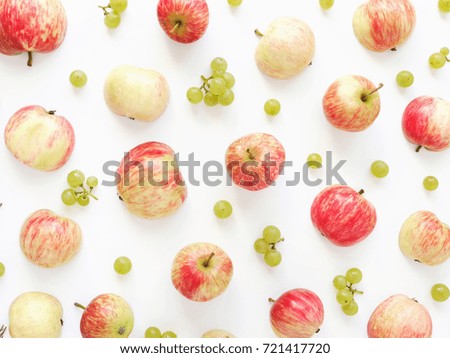 A composition of fruits  on a white background. Pattern made from fresh fruits: apples and grapes. Top view, flat design. 