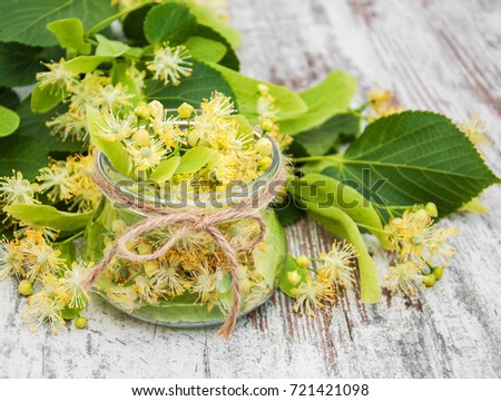 linden flowers in a jar on a old wooden table