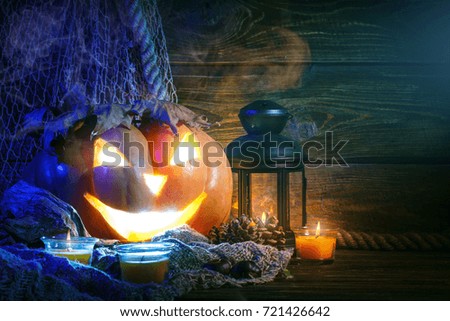 Halloween pumpkins on a wooden table at night.