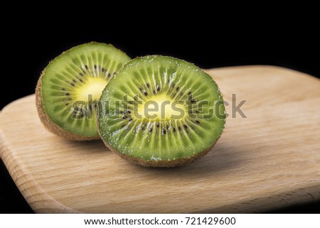 Kiwi on the black background?Fresh fruit cut