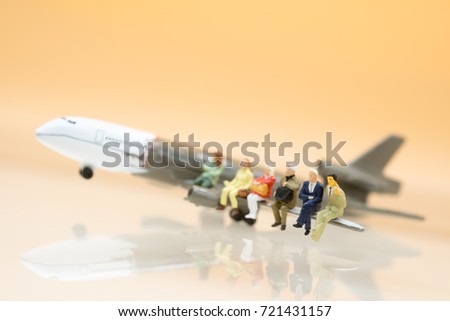 Miniature people: Businessman on airplane using as background travel or business concept.