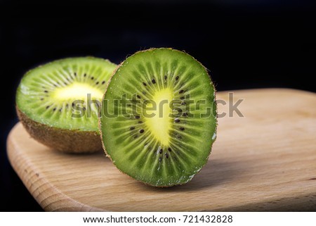 Fresh kiwi fruit cut on a black background