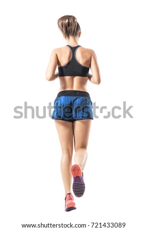 Backside view of fit female jogger jogging movement. Full body length portrait isolated on white studio background. 