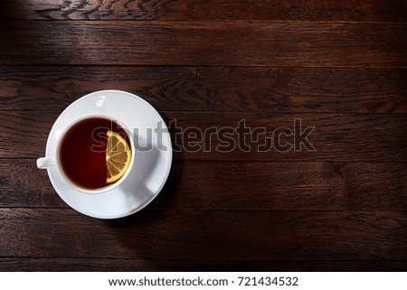 Cup of tea on a wooden background top view.