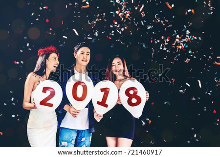 New year party ,celebration party group of asian young people holding balloon numbers 2018 happy and funny concept